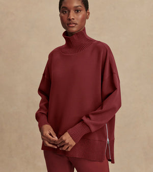 Model wearing Varley Barker high-neck oversized sweatshirt in soft DoubleSoft® fabric.