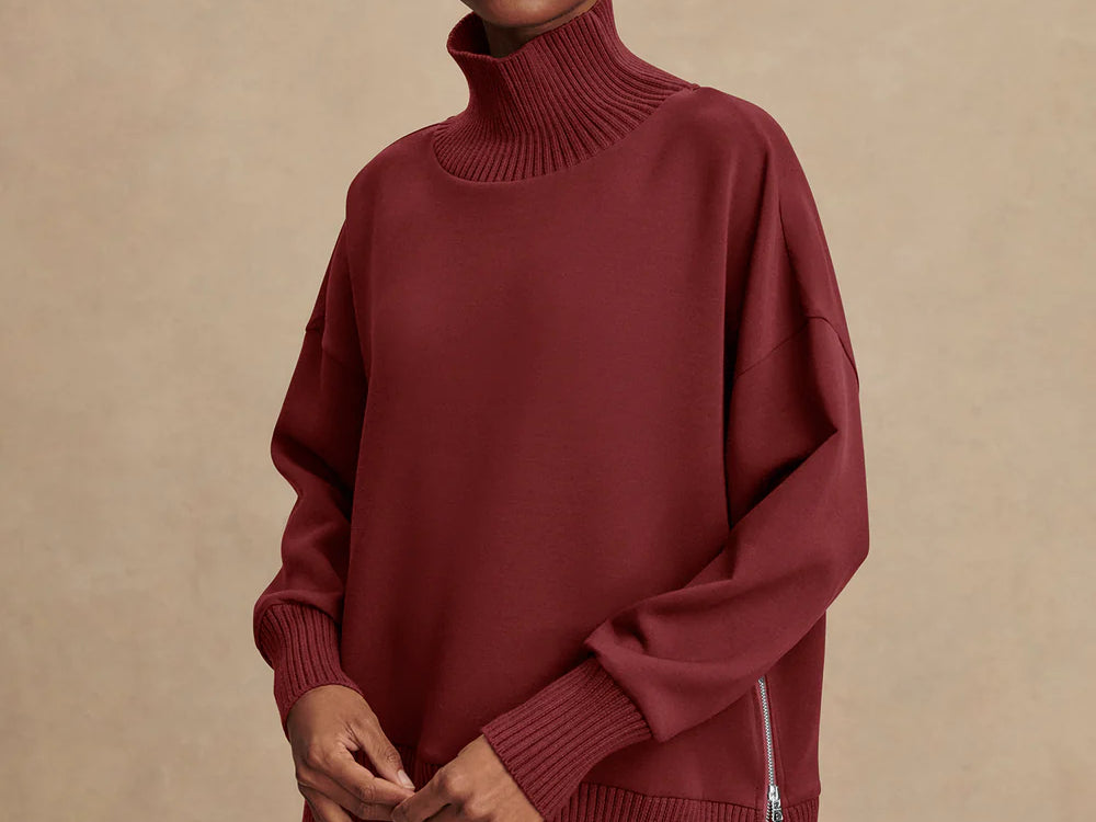 Model wearing Varley Barker high-neck oversized sweatshirt in soft DoubleSoft® fabric.