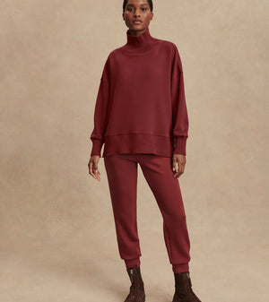 Model wearing Varley Barker high-neck oversized sweatshirt in soft DoubleSoft® fabric.