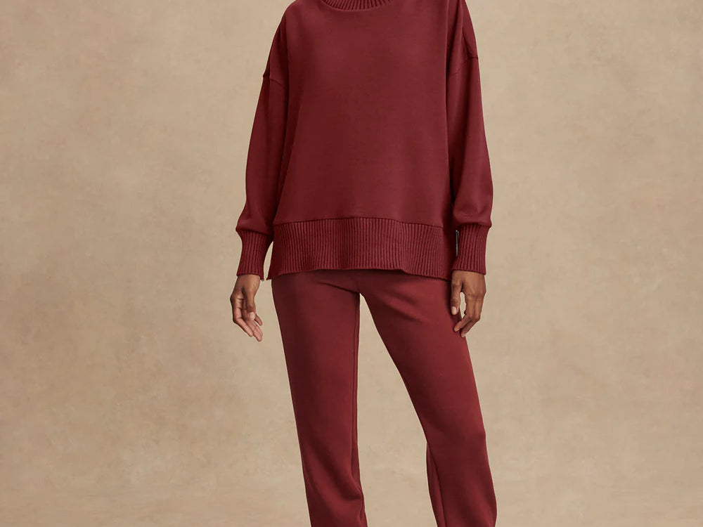 Model wearing Varley Barker high-neck oversized sweatshirt in soft DoubleSoft® fabric.