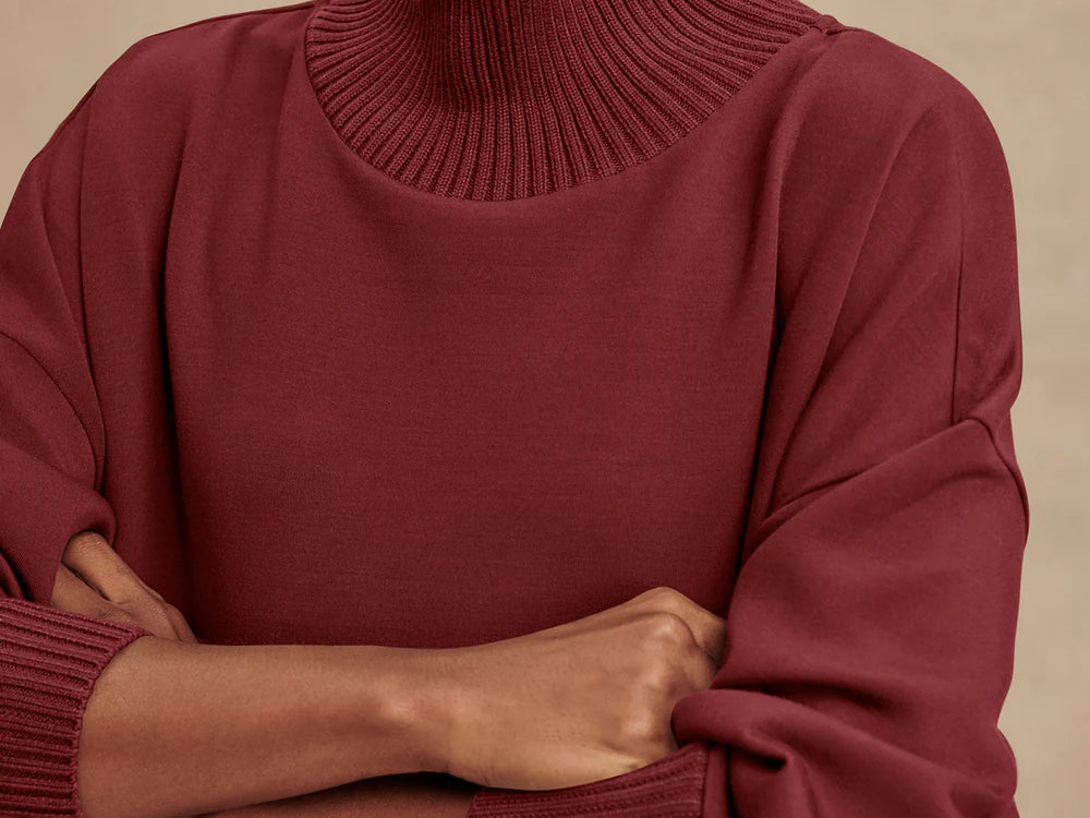 Model wearing Varley Barker high-neck oversized sweatshirt in soft DoubleSoft® fabric.