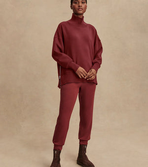 Model wearing Varley Barker high-neck oversized sweatshirt in soft DoubleSoft® fabric.