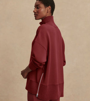 Model wearing Varley Barker high-neck oversized sweatshirt in soft DoubleSoft® fabric.