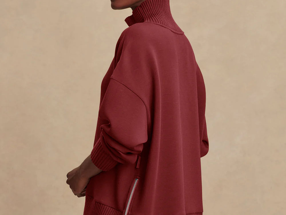 Model wearing Varley Barker high-neck oversized sweatshirt in soft DoubleSoft® fabric.