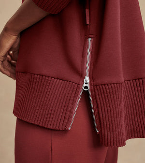 Model wearing Varley Barker high-neck oversized sweatshirt in soft DoubleSoft® fabric.