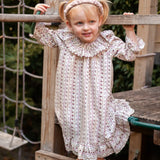 Beatrice Rose Stripe nightie, child standing on a wooden play frame in the frilled-collar floral striped nightie