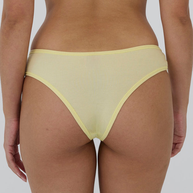 Ribbed mesh bikini bottom in pale yellow, shown from the back on a model against a light gray background.