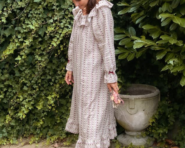 Beatrice Rose Stripe nightie side view on a barefoot woman outdoors, showing long sleeves and frilled hem