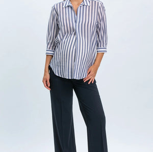 Woman wearing a striped shirt and black pants on a white background