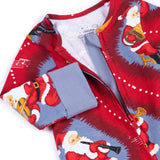 A close-up of a Christmas-themed zip-up pajama or long-sleeve top by Chelsea 1965, featuring a red and blue print of Santa Claus playing musical instruments, with a solid blue cuff.
