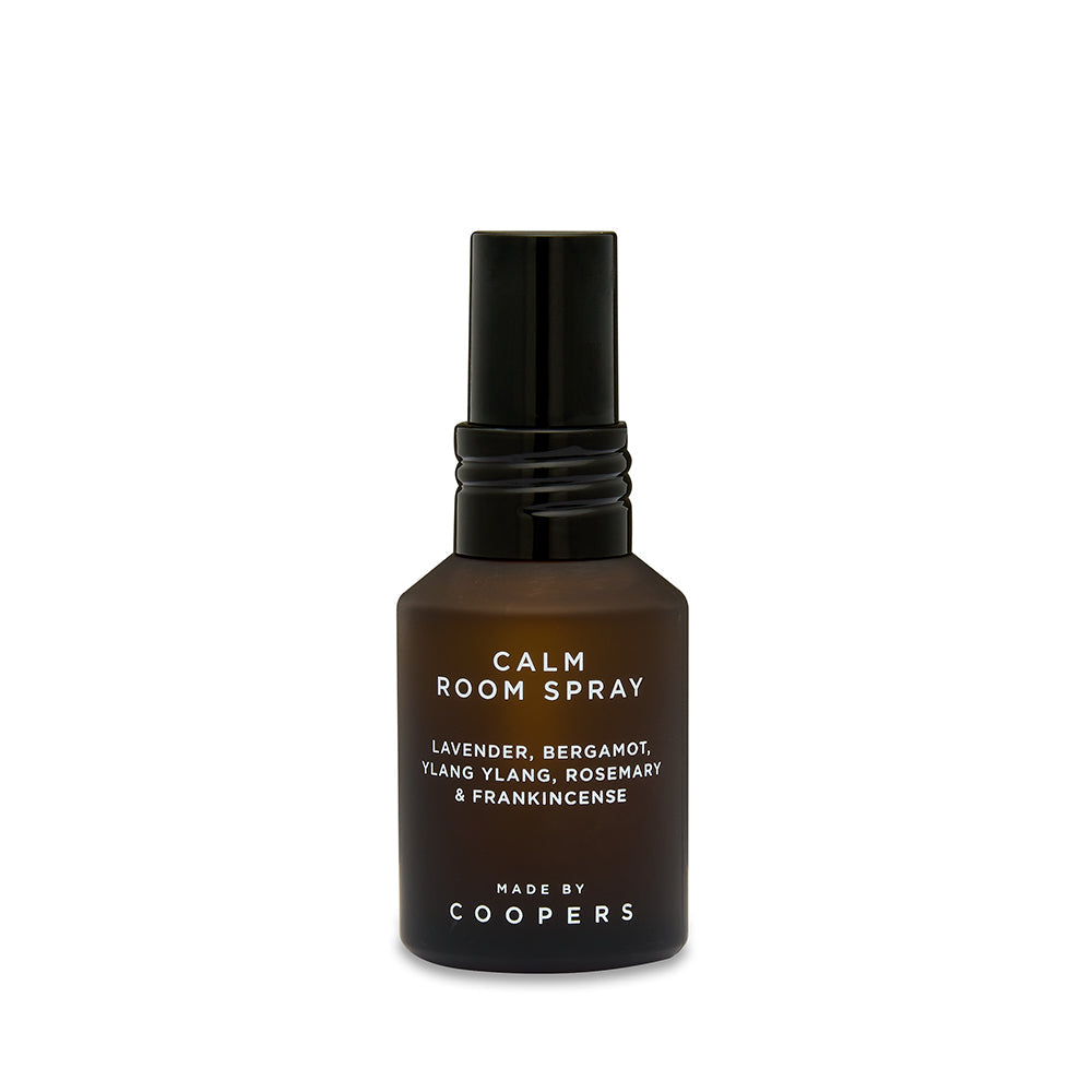 Calm Room Spray brown glass bottle with black spray top, front view on a white background