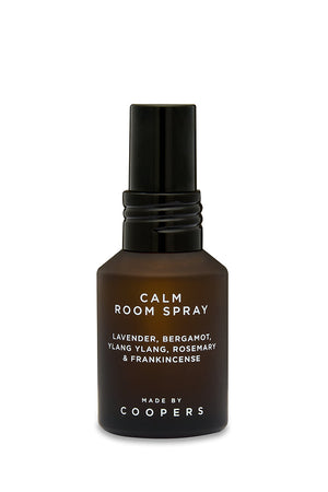 Calm Room Spray brown glass bottle with black spray top, front view on a white background