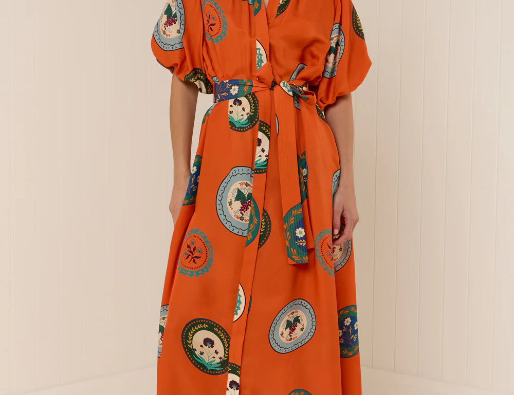 Model wearing Palm Noosa Carla Dress in Orange Plates print