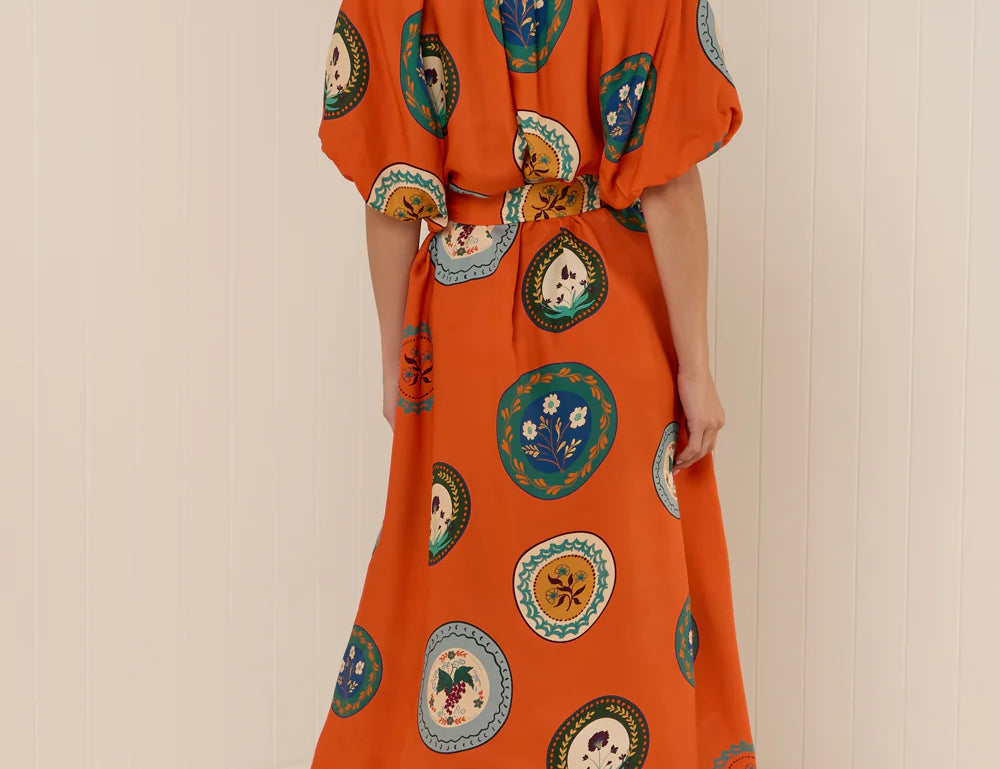 Model wearing Palm Noosa Carla Dress in Orange Plates print - Back view 