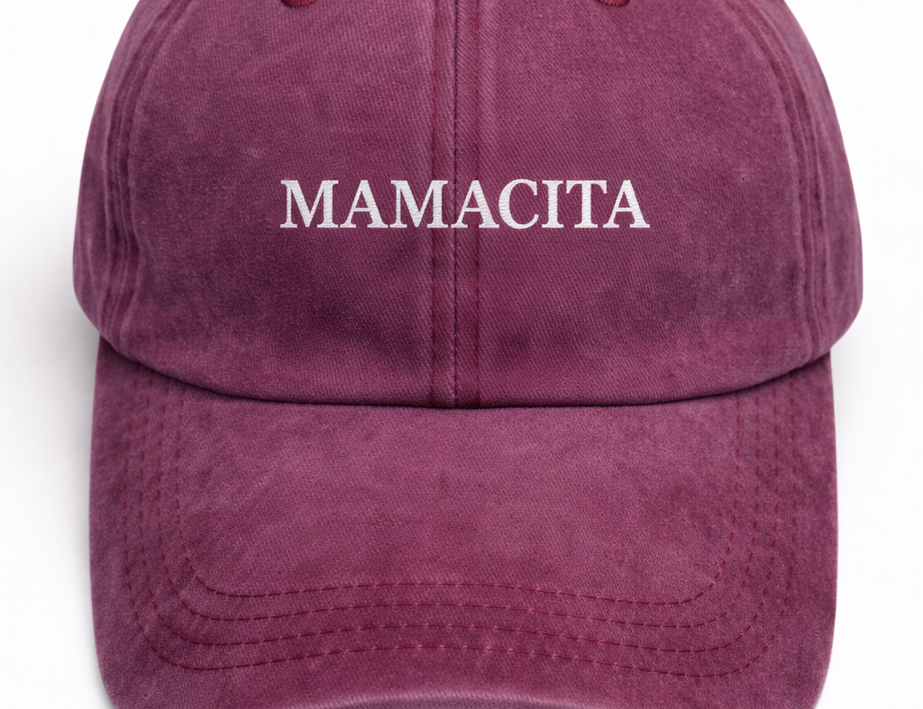 A washed purple baseball cap with 'MAMACITA' embroidered in white serif letters across the front, shown against a plain white background.