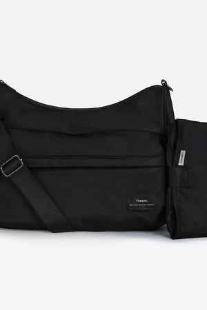 A black nylon shoulder bag with an adjustable shoulder strap and a matching zippered pouch attachment, shown on a light gray background.
