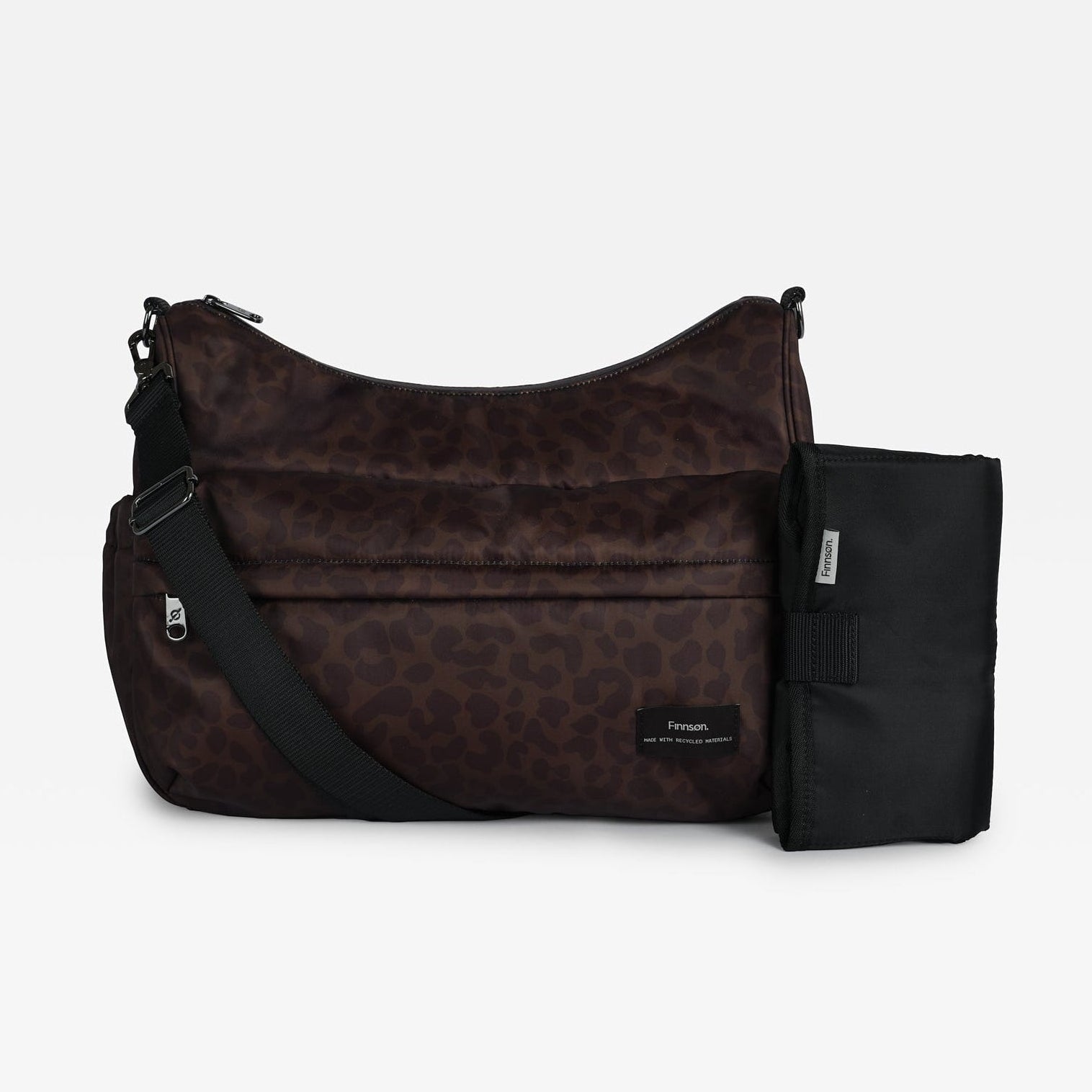 Clara Eco Changing Bag, Chocolate Leopard, front view with crossbody strap and black changing mat beside it