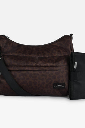 Clara Eco Changing Bag, Chocolate Leopard, front view with crossbody strap and black changing mat beside it
