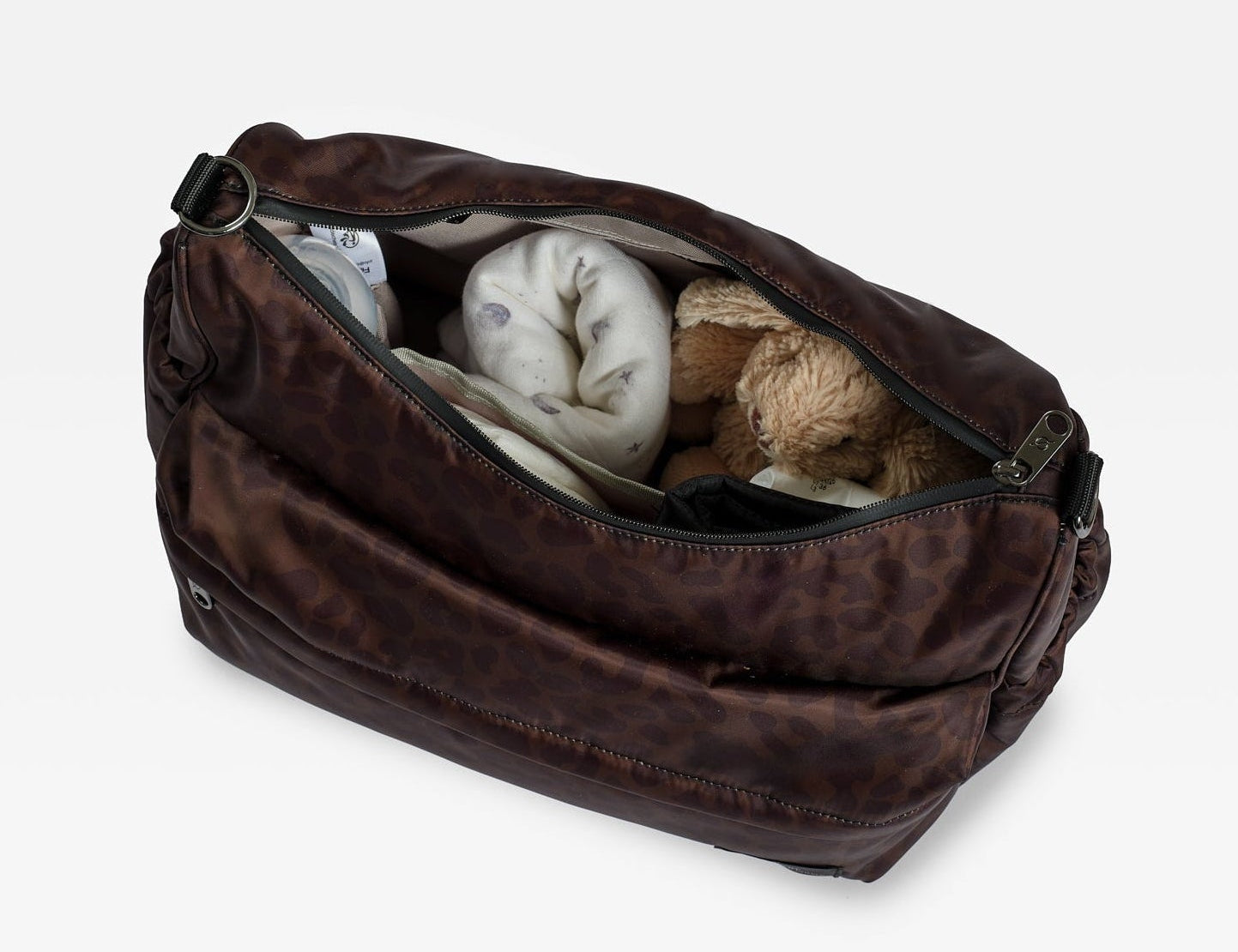 Clara Eco Changing Bag, Chocolate Leopard, top view with zip open showing a blanket and soft toy rabbit inside