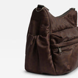 Clara Eco Changing Bag, Chocolate Leopard, close-up of the side pocket, front zip pocket and metal D-ring