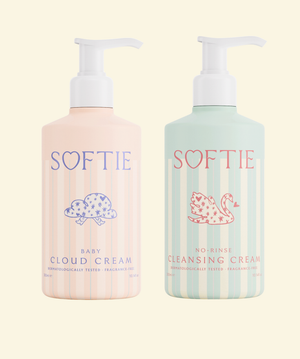 Two bottles of SOFTIE baby products on a light beige background