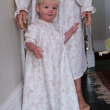 Baby Organic Cotton Nightie, Cordelia Toile: toddler in the pink toile nightie standing in front of an adult in a matching one