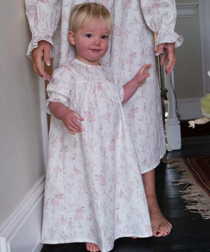 Baby Organic Cotton Nightie, Cordelia Toile: toddler in the pink toile nightie standing in front of an adult in a matching one