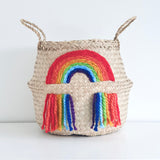 Vivid Rainbow Belly Basket, front view of woven basket with two handles and a woven rainbow with tassels