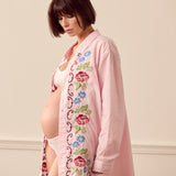 Pregnant woman wearing pink lounge shirt