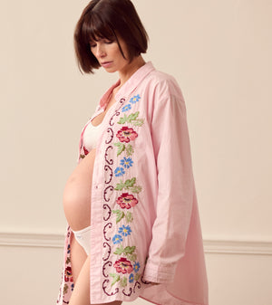 Pregnant woman wearing pink lounge shirt