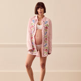 Pregnant woman wearing pink lounge shirt