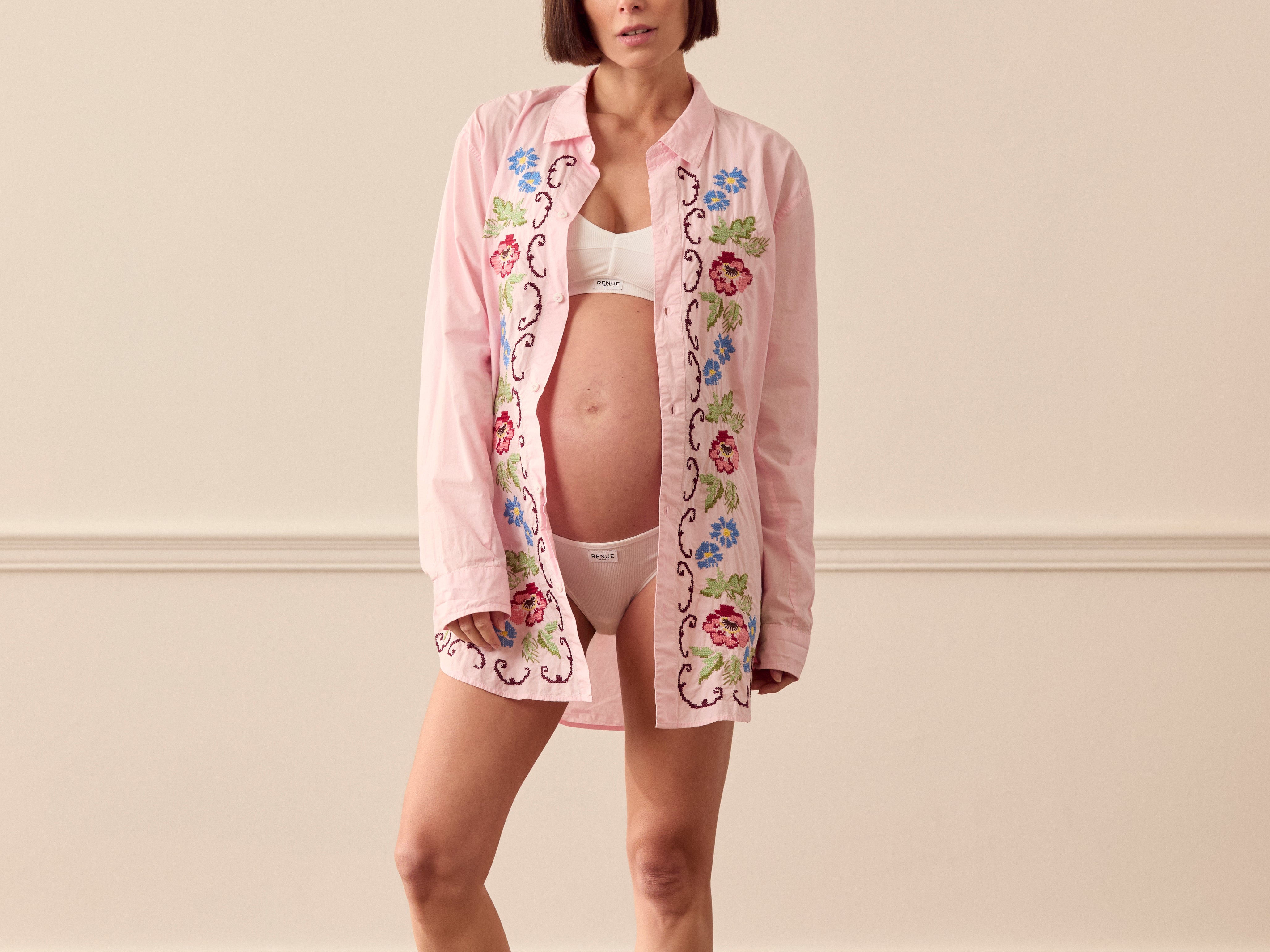 Pregnant woman wearing pink lounge shirt