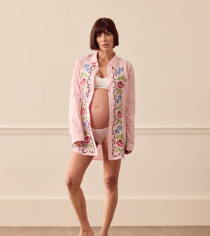 Pregnant woman wearing pink lounge shirt