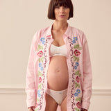 Pregnant woman wearing pink lounge shirt
