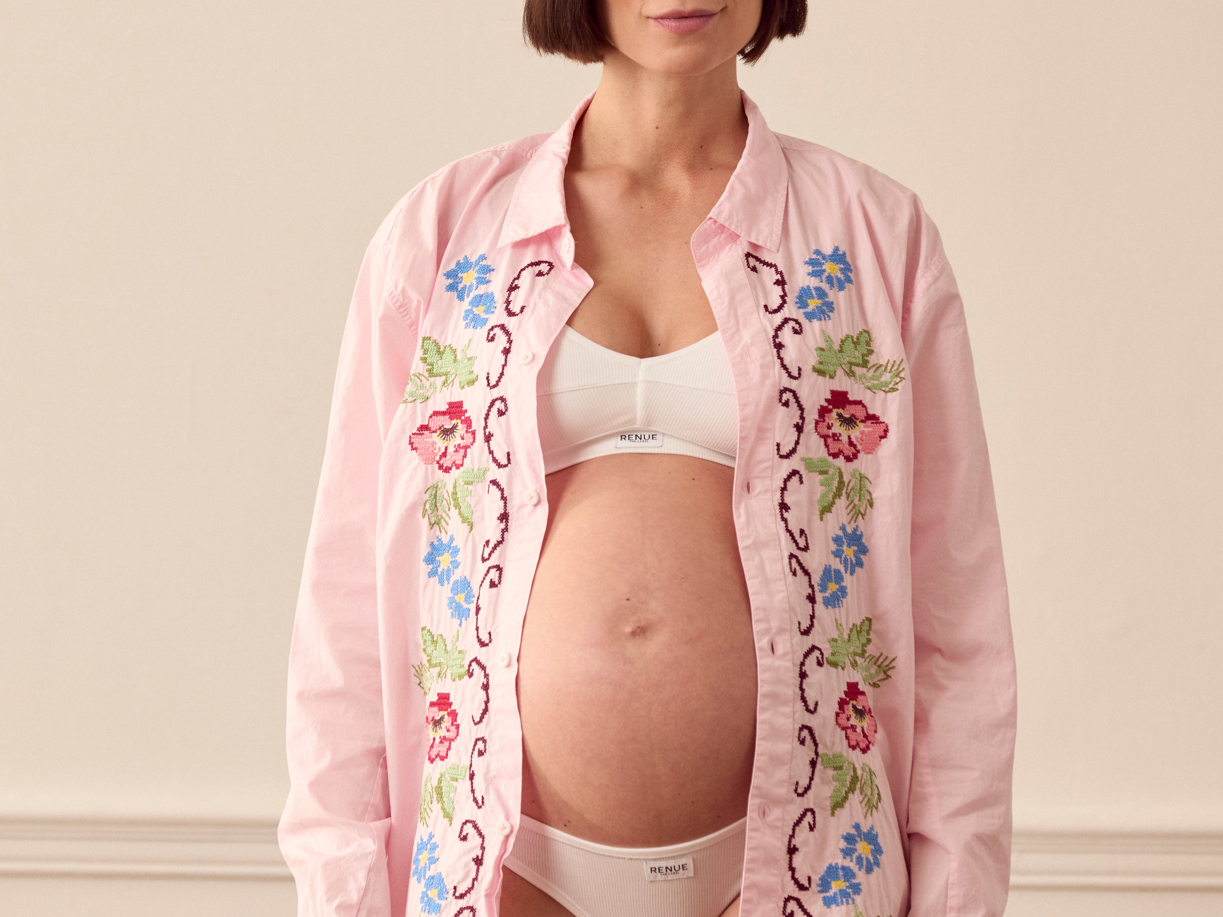 Pregnant woman wearing pink lounge shirt
