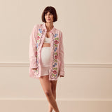 Pregnant woman wearing pink lounge shirt
