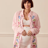Pregnant woman wearing pink lounge shirt