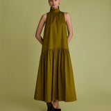 Woman wearing khaki green dress with high neck, sleeveless and a line shape