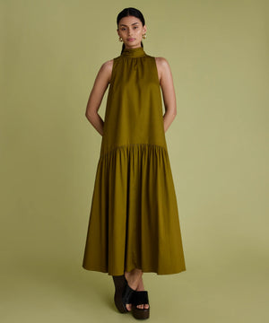 Woman wearing khaki green dress with high neck, sleeveless and a line shape