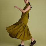 Woman wearing a green dress on a matching background