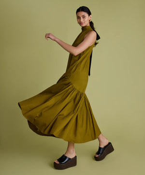 Woman wearing a green dress on a matching background