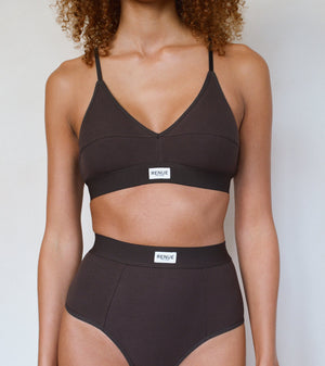 A model wearing a dark brown two-piece bikini set with a scoop neck top and high-waisted bottoms, featuring a small white brand label that reads 'HENDT'.