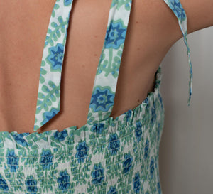 Close-up of a floral dress with shoulder tie design.