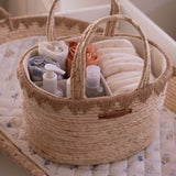 Woven basket with baby items on a crib