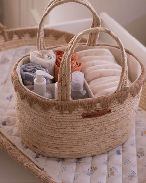Woven basket with baby items on a crib
