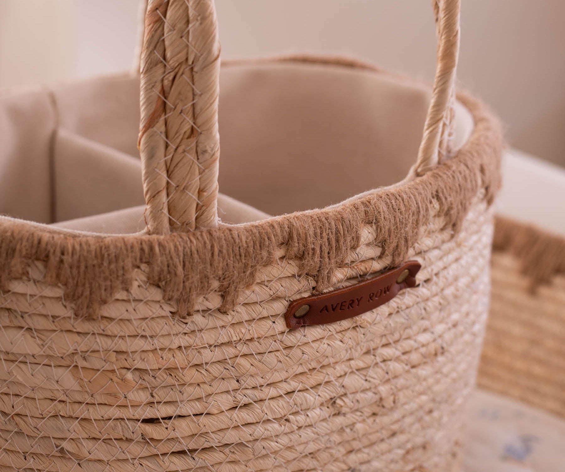 Close-up of a woven basket with a handle and visible brand label.