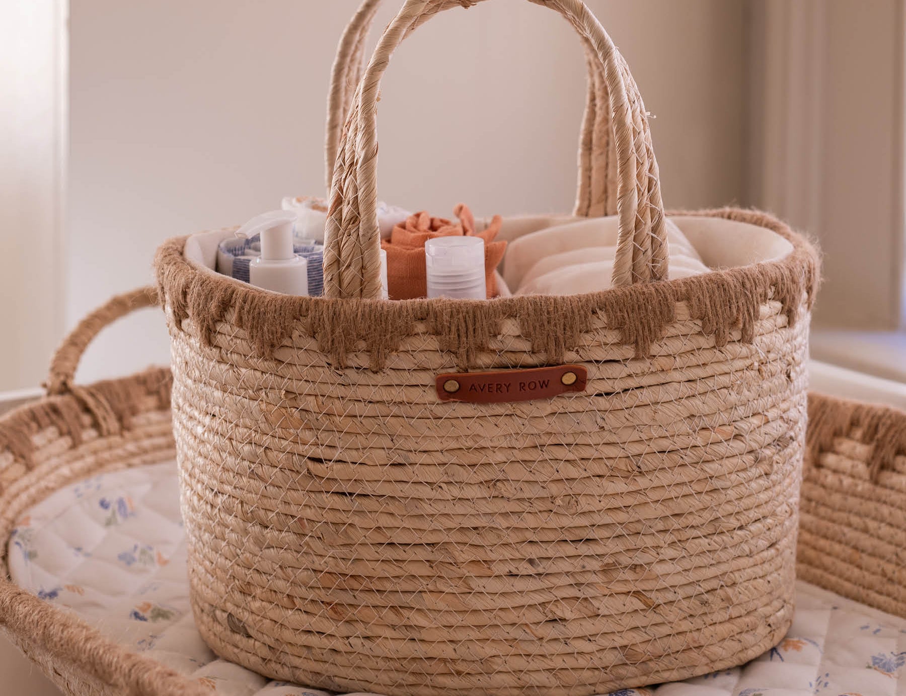 Woven basket with baby items on a crib