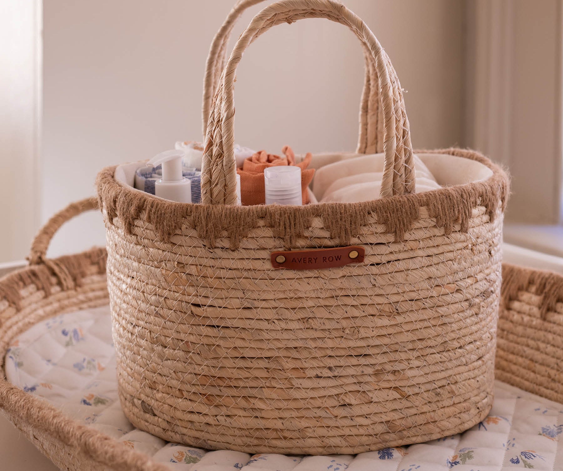 Woven basket with baby items on a crib