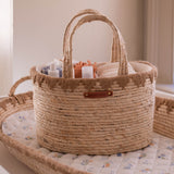 Woven basket with baby items on a crib
