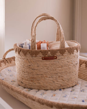 Woven basket with baby items on a crib